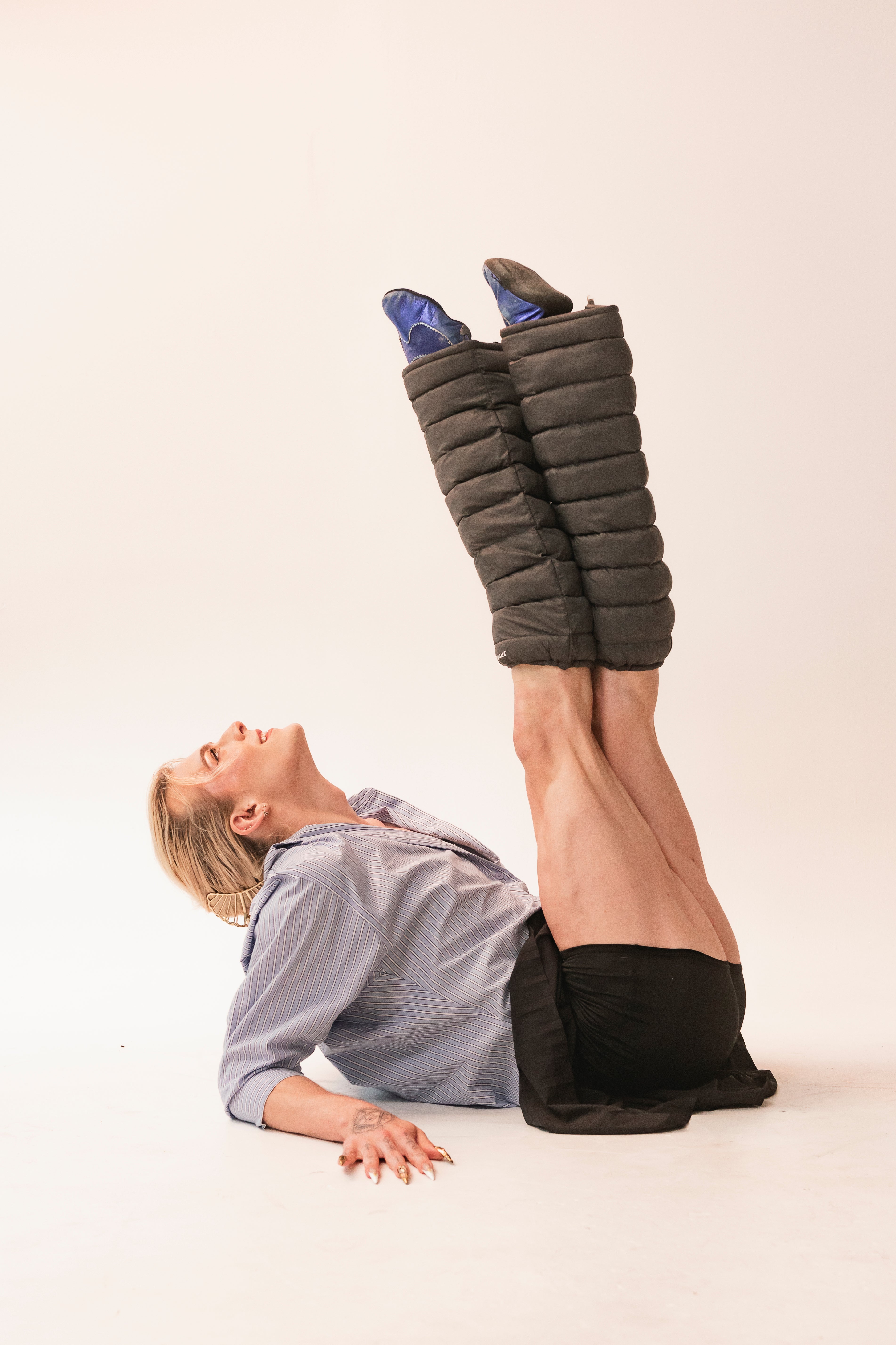 Dancer with legs raised wearing Charcoal LegPuffs