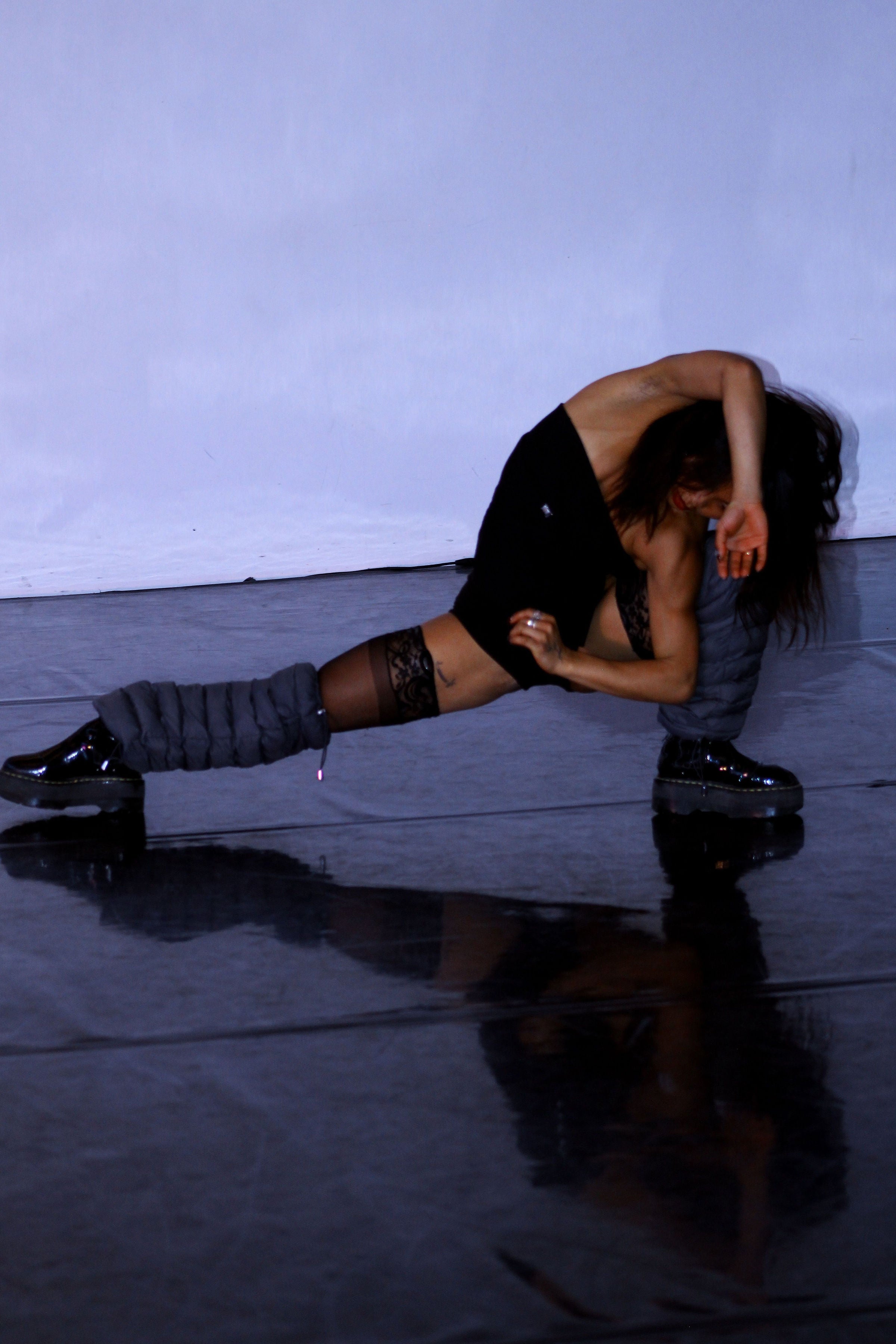Dancer in a floor pose wearing Charcoal LegPuffs
