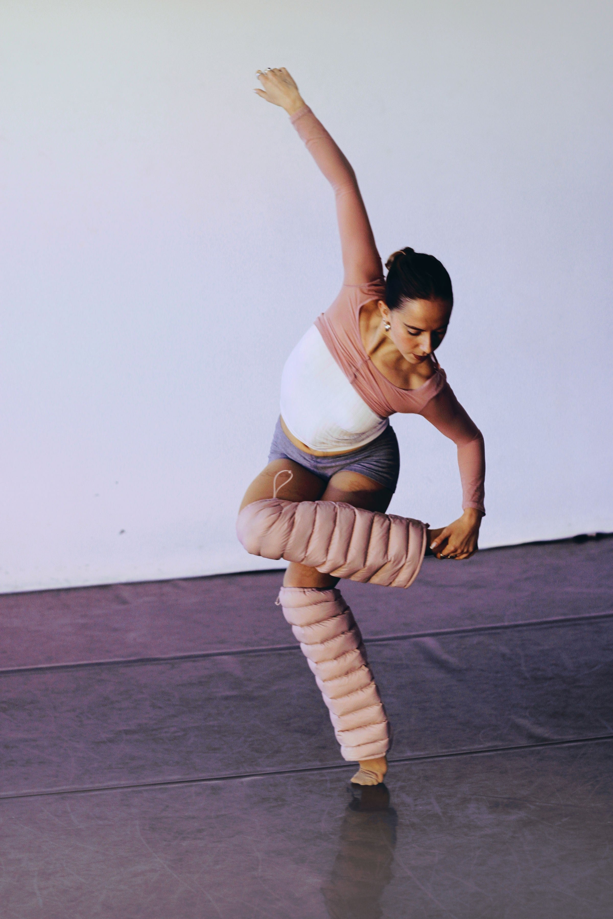 Dancer mid-movement in the studio wearing Mauve LegPuffs