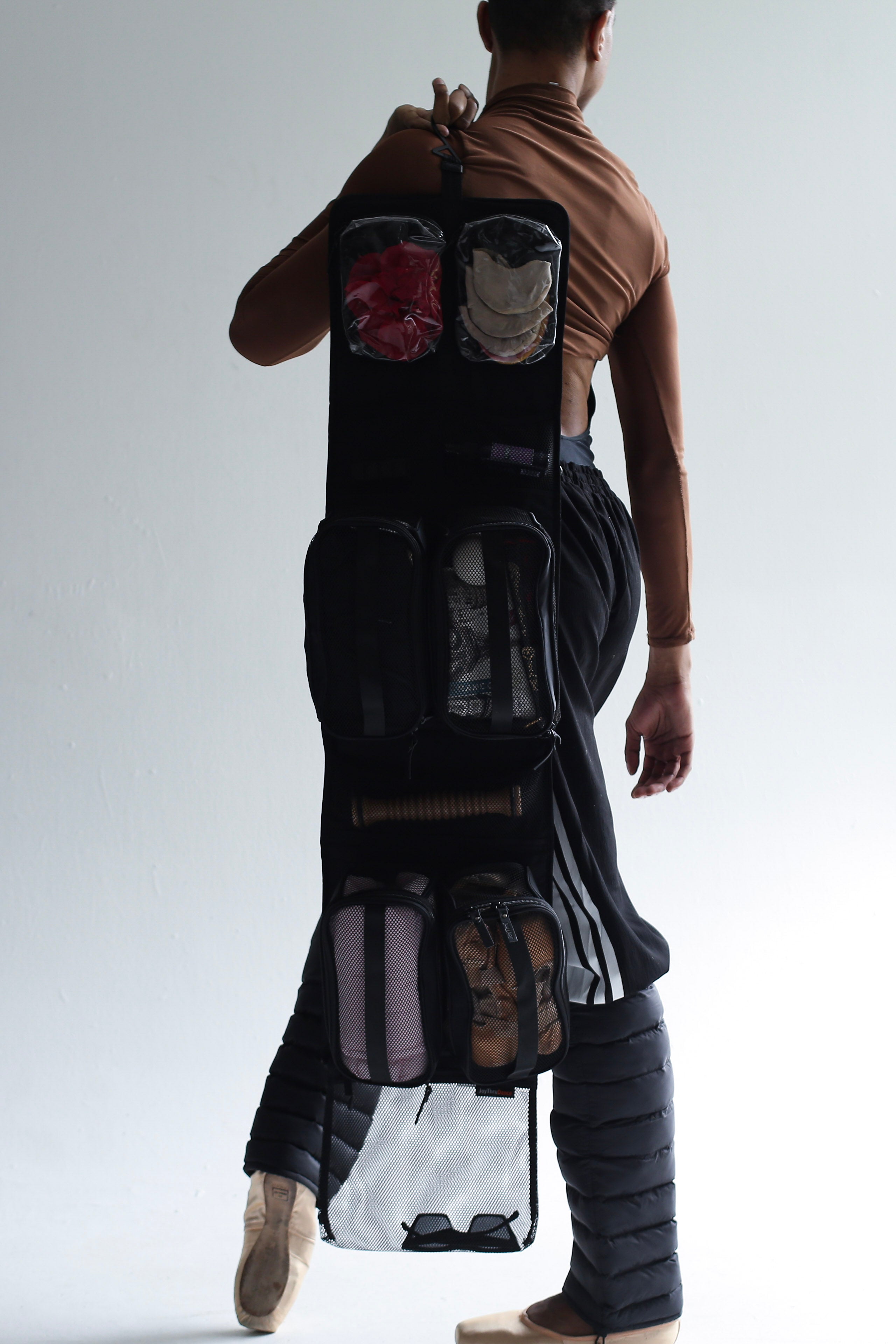 Model wearing the JoyThru Dance Bag Organizer with Onyx LegPuffs