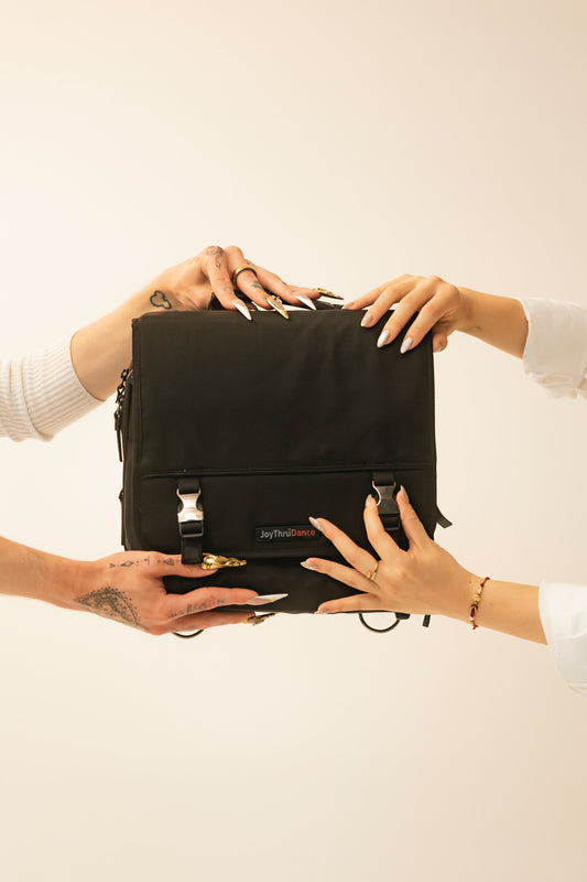 Hands presenting the JoyThru Dance Bag Organizer, front view