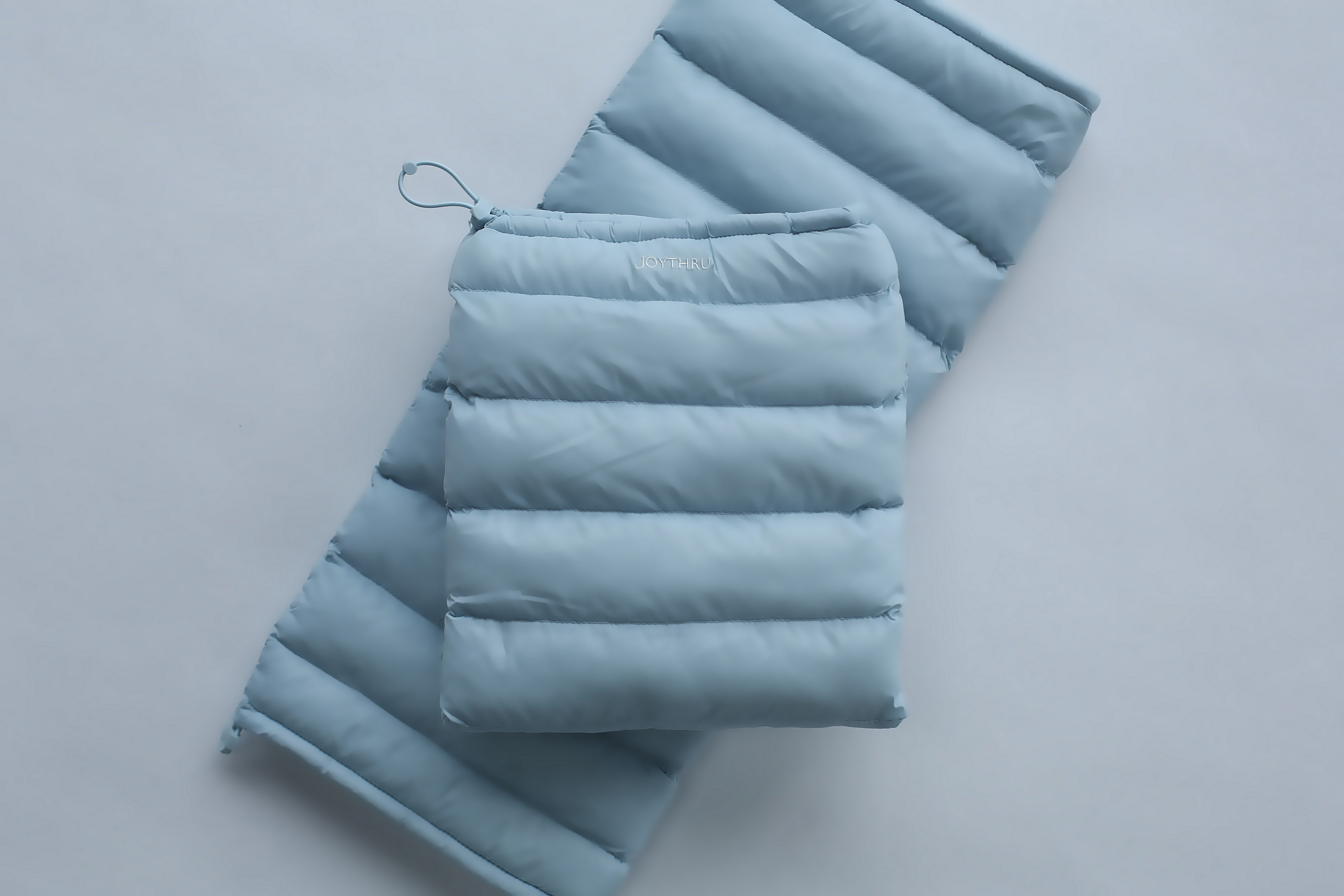 Sky LegPuffs folded, flatlay on white