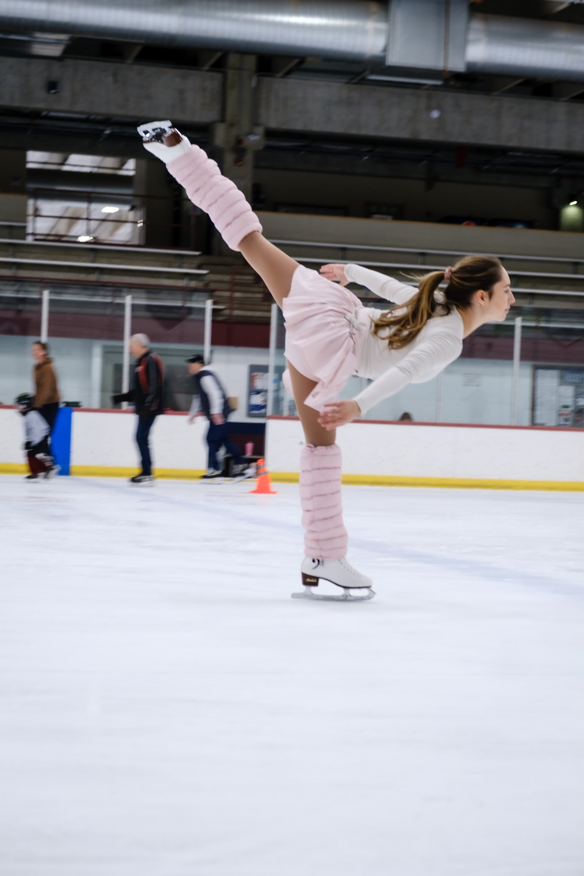Figure skater on ice wearing blush LegPuffs
