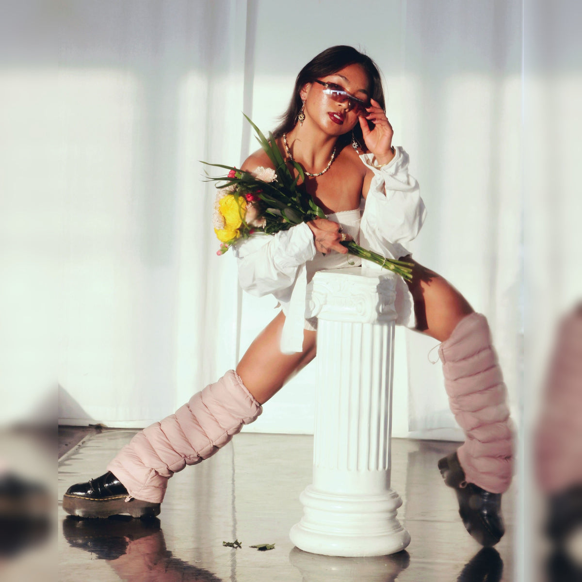 Model with flowers wearing Mauve LegPuffs and platform boots