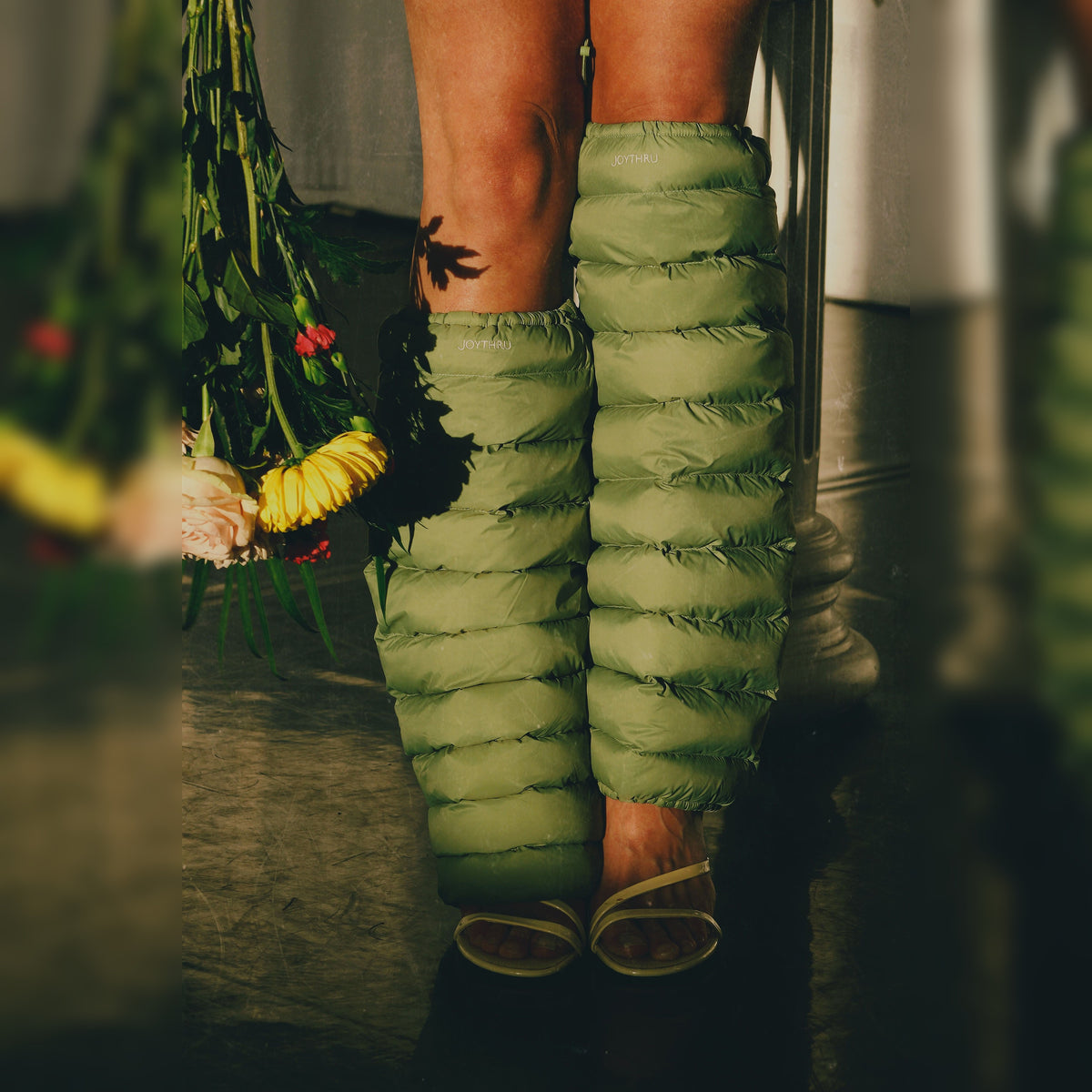 Close-up of Sage LegPuffs worn with heeled sandals, model holding flowers