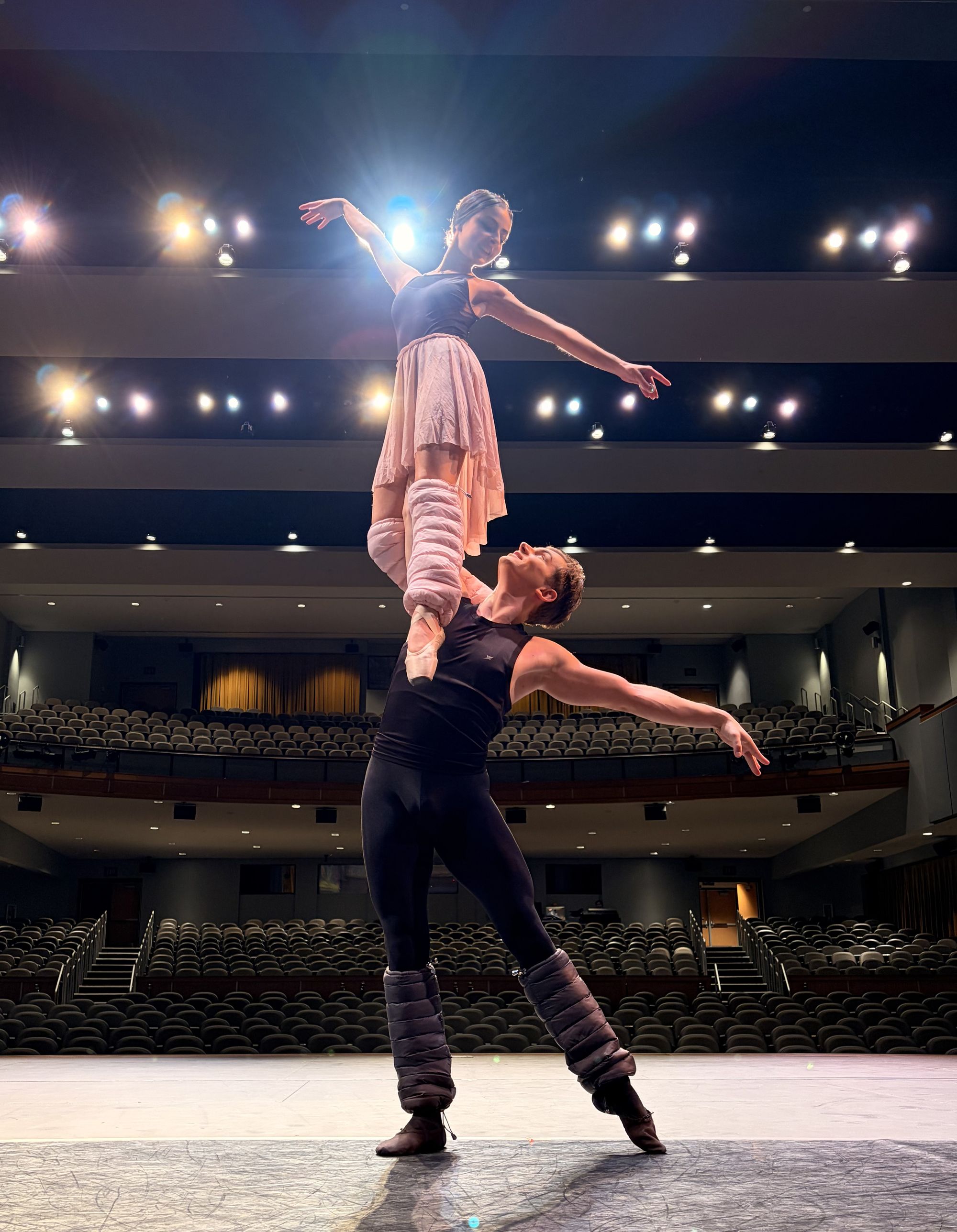 Dancers performing a stage lift, wearing blush LegPuffs